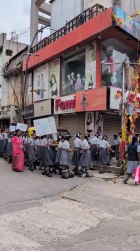 School procession passes elephant statue on Bengaluru street
