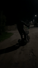 Person rides, repairs electric scooter on dark Bulgarian road