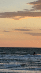 Kitesurfer rides waves at sunset near Shcholkino, Ukraine
