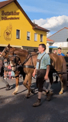 Historical street parade winds through Buttstädt with horses, bands, and costumes