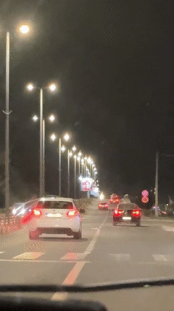 Evening traffic flows on lit Podgorica street