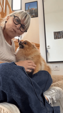 Woman enjoys quiet morning with Pomeranian in Chambœuf