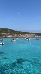 Boats anchored in clear turquoise water off Neo Chorio, Cyprus