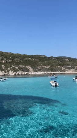 Boats anchored in clear turquoise water off Neo Chorio, Cyprus