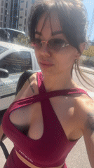 Woman in magenta sports bra recorded outdoors