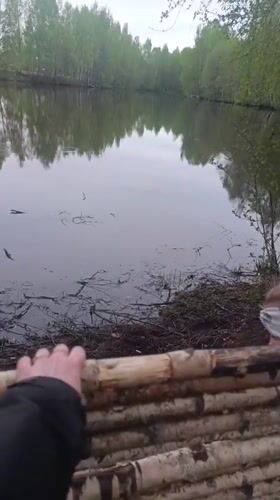 Children play on makeshift rafts at Chernogolovka lake