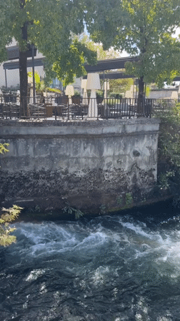 Turbulent Charente River and waterfront buildings in Cognac
