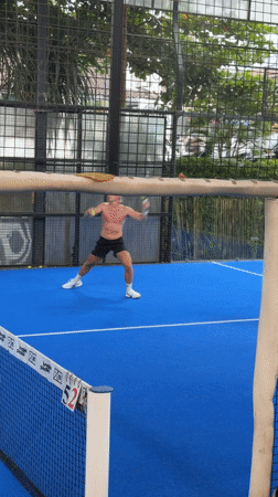 Two men play paddle tennis in Mengwi, Indonesia