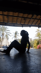 Woman performs yoga poses at outdoor pavilion in Porlamar