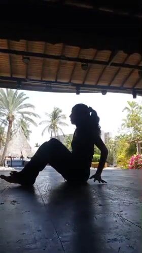 Woman performs yoga poses at outdoor pavilion in Porlamar