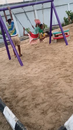 Kids at a Lagos playground, skates on the ground at dusk