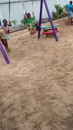 Kids at a Lagos playground, skates on the ground at dusk