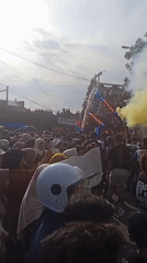 Costumed parade with decorated float draws crowds in Winong