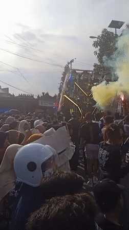 Costumed parade with decorated float draws crowds in Winong