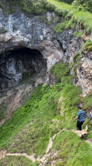 Tourists explore Pozu Funeres sinkholes in mountainous Riosa, Spain
