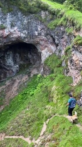 Tourists explore Pozu Funeres sinkholes in mountainous Riosa, Spain