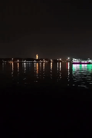 Hyderabad lake captures city skyline reflections in nighttime video
