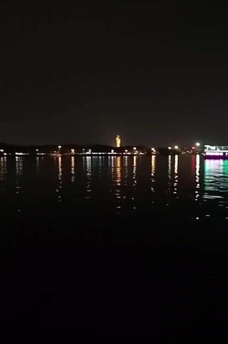 Hyderabad lake captures city skyline reflections in nighttime video