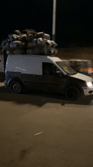 Nighttime street market bustles with vendors and shoppers in Bukuru