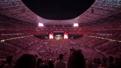 Stadium concert night in Budapest, big screens and packed crowds