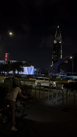 Helmeted person stands against Shenzhen skyline in Nanshan District