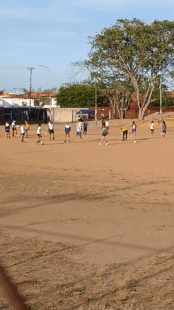 Young people play soccer on dusty field in Ciudad Guayana