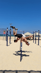 Two men perform morning calisthenics workout on Tel Aviv beach