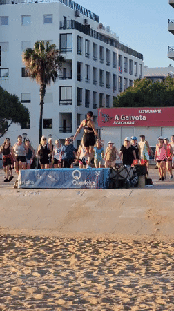 Beachfront dance fitness class on the Quarteira promenade at sunset