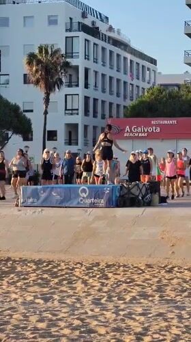 Beachfront dance fitness class on the Quarteira promenade at sunset