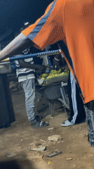 Night market activity on a dirt road in Abuja