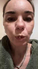 Woman in green sweatshirt observed making expression in Vsevolozhsk
