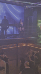 Dance performer entertains nightclub crowd from elevated platform in Prague