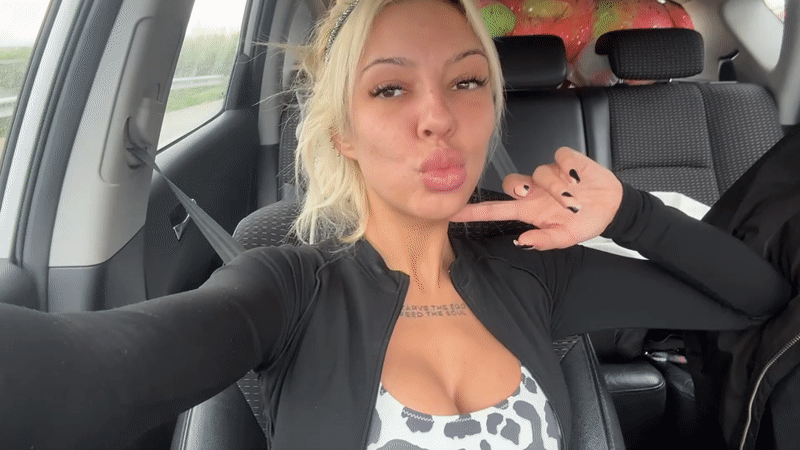 Woman records selfie video from car in Bulgarian village