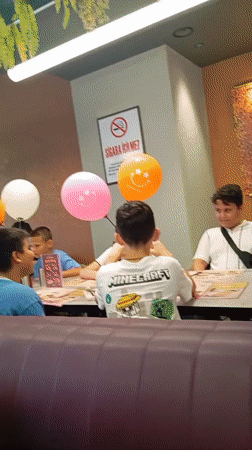 Birthday gathering at a Konyaaltı restaurant, balloons and food in view