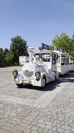White toy train on cobblestone in Camaiore's open air