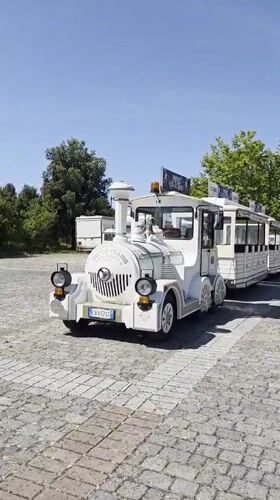 White toy train on cobblestone in Camaiore's open air