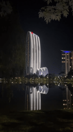 Illuminated Marriott hotel complex reflected in Batumi waters