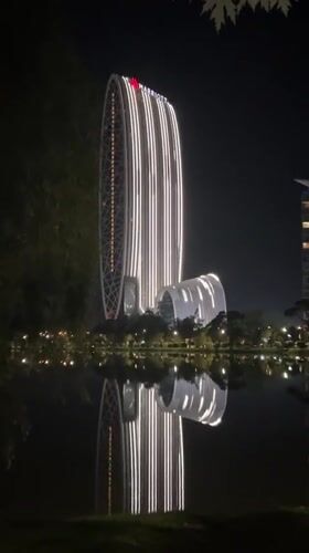 Illuminated Marriott hotel complex reflected in Batumi waters