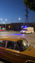 Emergency vehicles respond in Krasnodar street scene at dusk