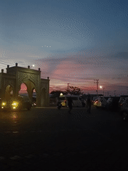Dusk to nightfall around a lit mosque in Mee Tanjong Usi