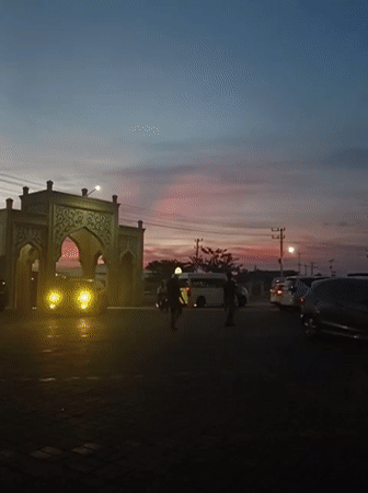 Dusk to nightfall around a lit mosque in Mee Tanjong Usi