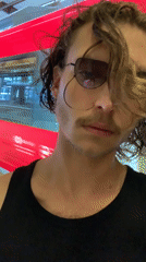 Man poses by train, dog rests indoors in Tel Aviv