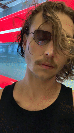 Man poses by train, dog rests indoors in Tel Aviv