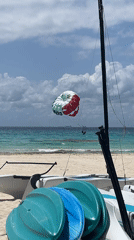 Parasailing and beach activities observed in Playa del Carmen