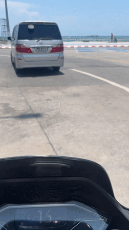 Silver minivan spotted on Pattaya coastal road during sunny weather