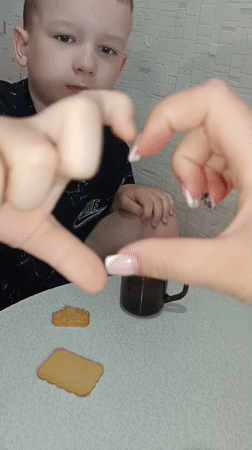 Heart gesture shared at table gathering in Tobolsk
