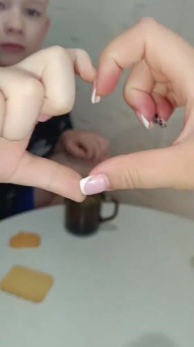 Heart gesture shared at table gathering in Tobolsk