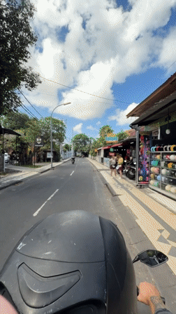 Morning motorcycle ride documented through Kuta streets and local establishment