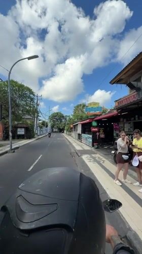 Morning motorcycle ride documented through Kuta streets and local establishment