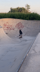 Skaters and BMX riders session a Barcelona bowl at sunset